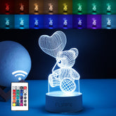 Lampa LED decorativa, Kaveny, 3D, Ursulet cu balon inima, cu telecomanda, doua moduri de alimentare USB si baterii, 20 cm inaltime, din material acril si lumina multicolora, alb