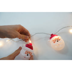 Instalatie Craciun cu ornamente Mos Craciun cu caciula rosie, 1 m, 10 LED-uri, Alb Cald, Baterii, Fir Transparent, Kaveny