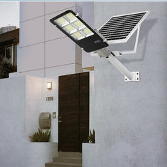 Lampa solara stradala Kaveny, IP65, senzor de lumina, 100 LED-uri SMD, 7200 lm, panou 12W, putere 80W, autonomie 12-16 ore, telecomanda, montare prin fixare, pentru strada sau gradina, finisaj lucios, material ABS, 38.6 x 13.3 x 6.5 cm, lumina alb rece