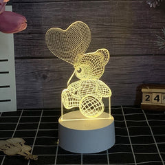 Lampa LED decorativa, Kaveny, 3D, Ursulet cu balon inima, cu telecomanda, doua moduri de alimentare USB si baterii, 20 cm inaltime, din material acril si lumina multicolora, alb