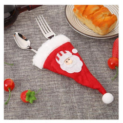 Husa decorativa festiva pentru 3 tacamuri Kaveny, model caciulita cu Mos Craciun, material textil si poliester, 19 x 10 cm, rosu