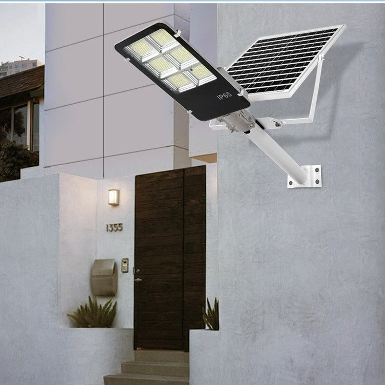 Lampa solara stradala Kaveny, IP65, senzor de lumina, 100 LED-uri SMD, 7200 lm, panou 12W, putere 80W, autonomie 12-16 ore, telecomanda, montare prin fixare, pentru strada sau gradina, finisaj lucios, material ABS, 38.6 x 13.3 x 6.5 cm, lumina alb rece